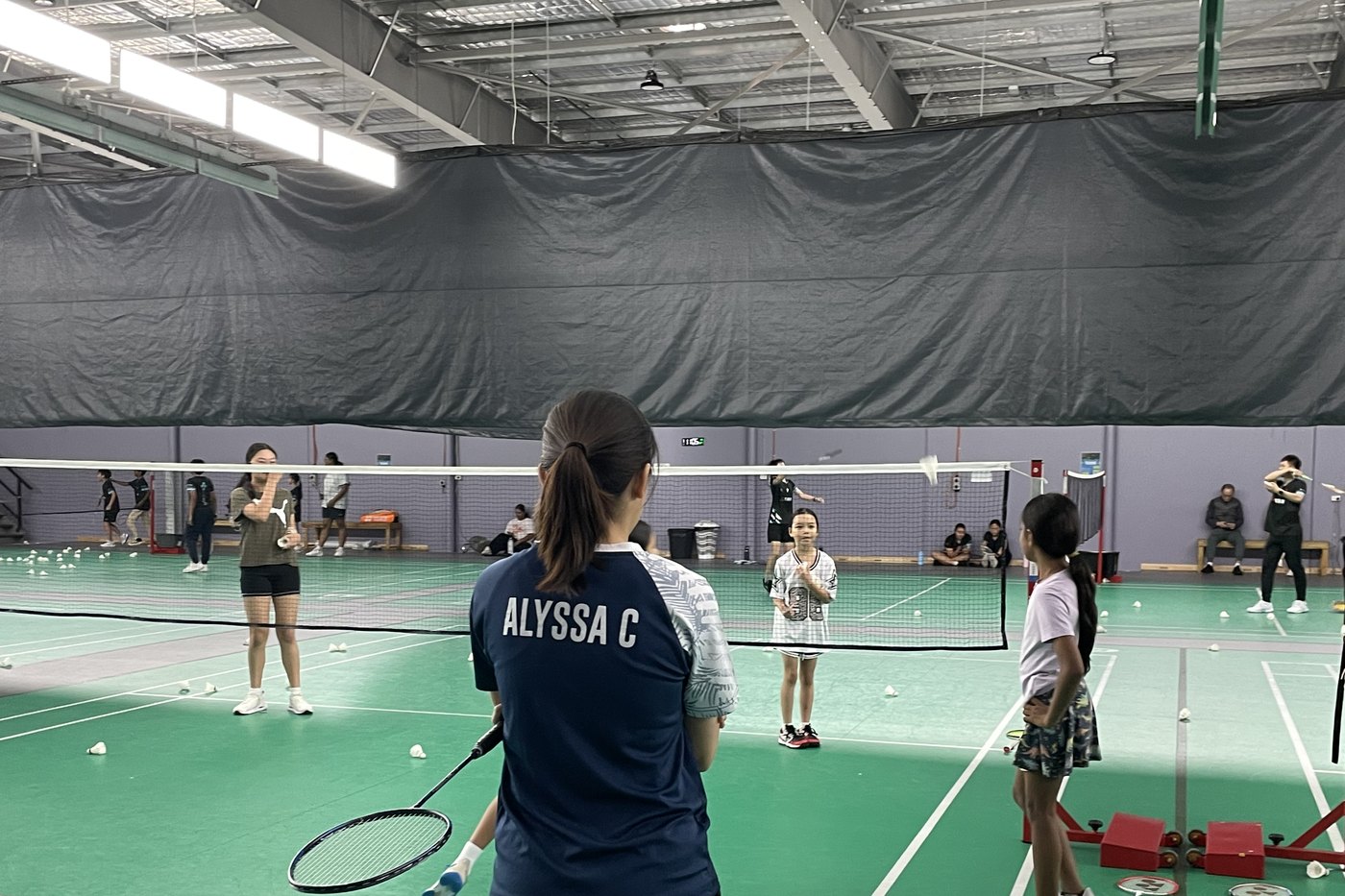 Badminton racket and shuttlecocks on an indoor court
